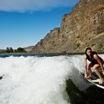 Woman wakesurfing on river