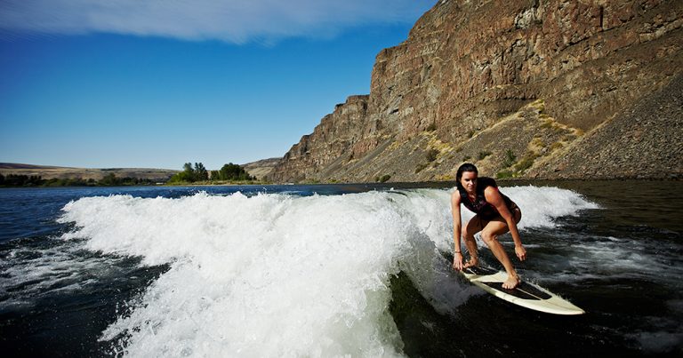 Woman wakesurfing on river